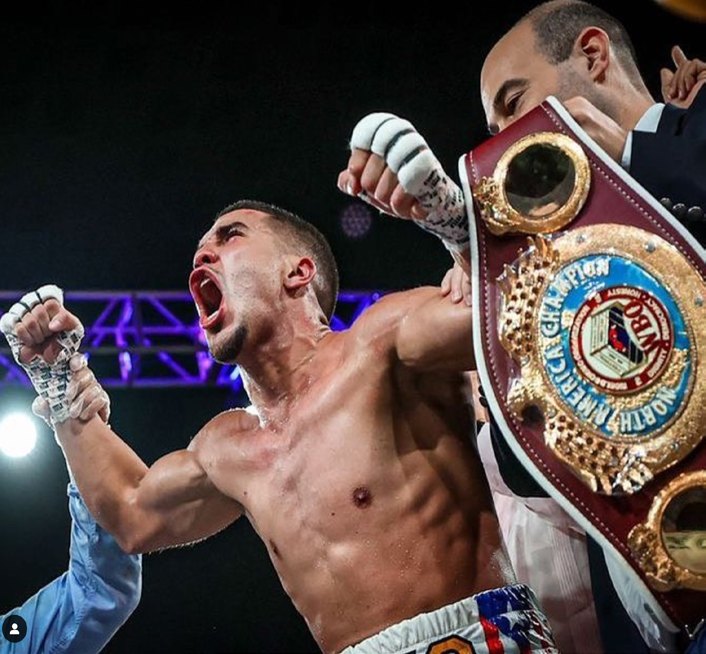 Nestor Bravo roaring with his championship belts